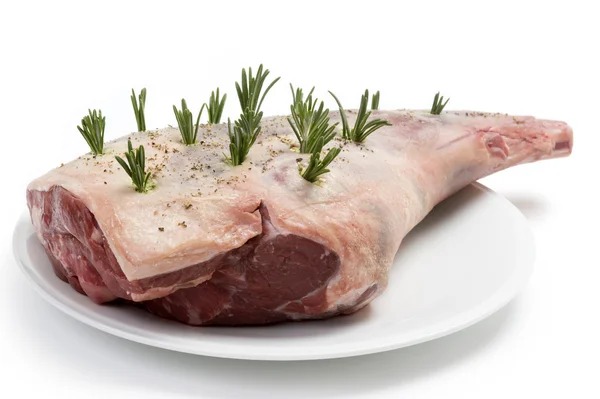Raw leg of lamb with rosemary and pepper — Stock Photo, Image