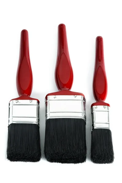 Drie rode verf penselen — Stockfoto