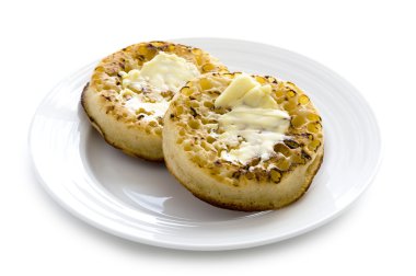 Hot toasted crumpets with butter clipart