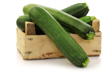 Fresh zucchini's in a wooden box clipart