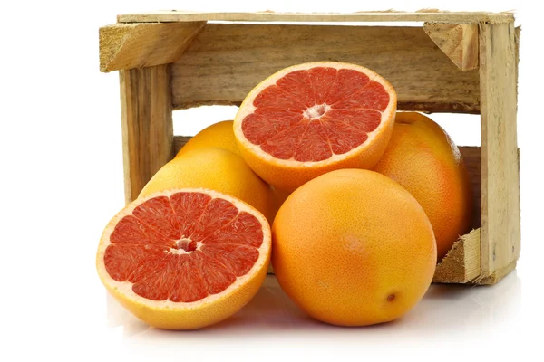 Fresh red grapefruits in a wooden box — Stock Photo, Image