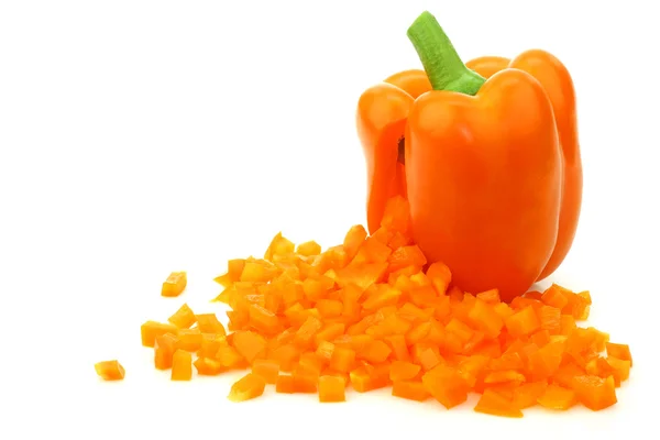 Fresh orange bellpepper with cut pieces of paprika — Stock Photo, Image