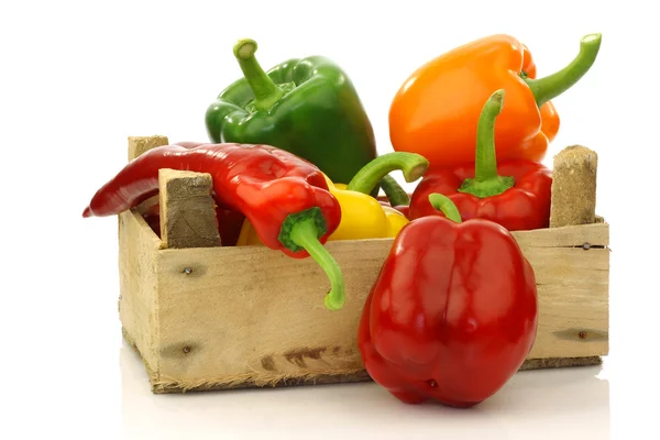 Colorful mix of paprika's(capsicum) in a wooden box — Stock Photo, Image