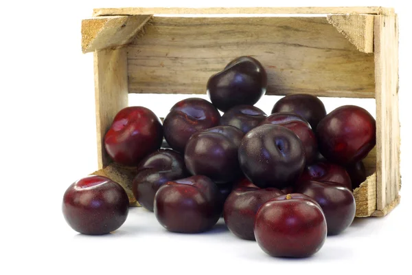 Fresh plums in a wooden crate — Stock Photo, Image
