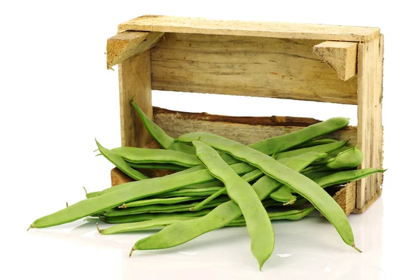Bunch of string beans coming from a wooden box — Stock Photo, Image
