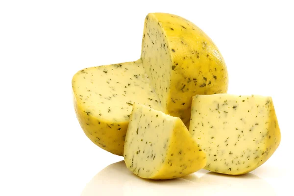 Cut traditional Gouda cheese with herbs — Stock Photo, Image
