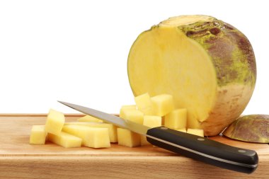 One fresh cut turnip(Brassica rapa rapa) with a kitchen knife clipart