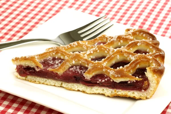 Slice of decorated cherry pie called "vlaai" — Stock Photo, Image