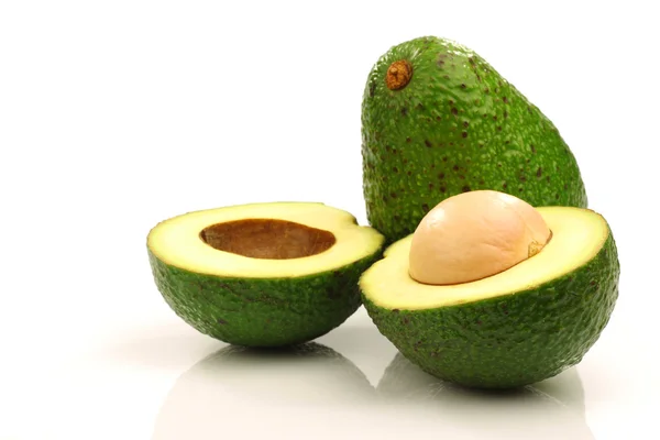 One whole and one cut avocado — Stock Photo, Image