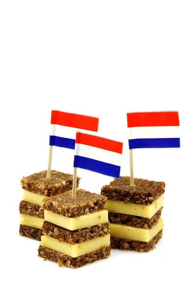 Layered rye bread and cheese snacks with Dutch flag toothpick — Stock Photo, Image