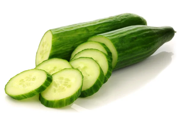 stock image Two cut cucumber halves and some pieces