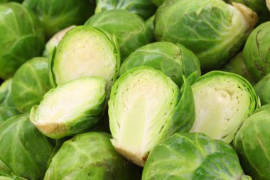 Background of freshly cut brussel sprouts and some whole ones clipart