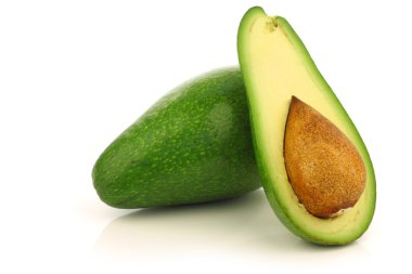 Fresh and ripe avocado and a cut one clipart