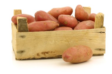 Fresh roseval potatoes ina wooden box clipart