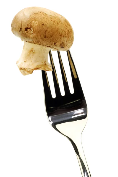 Färska hela champinjon svamp på en gaffel — Stockfoto