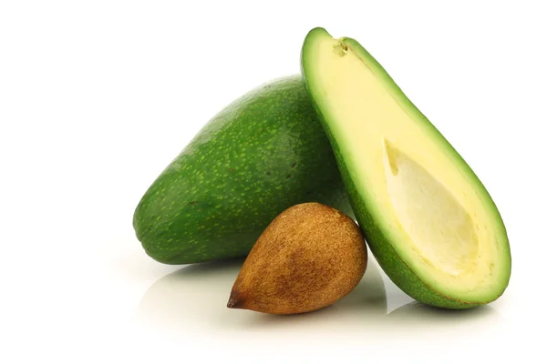 Fresh and ripe avocado and a cut one — Stock Photo, Image