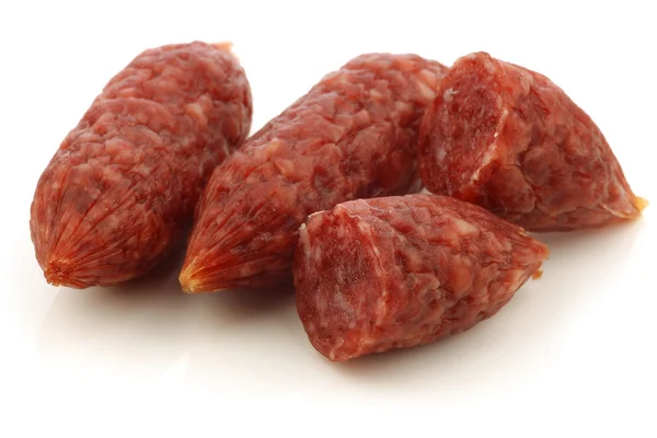Small cervelat sausages and a cut one — Stock Photo, Image