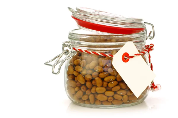 Lots of brown beans in a glass jar with room for text — Stock Photo, Image