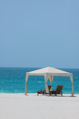 White gazebo on a beach resort clipart