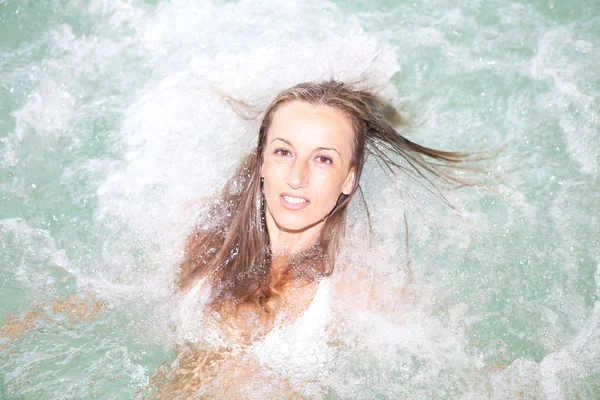 stock image Young woman relaxing inside a hydromassage bath