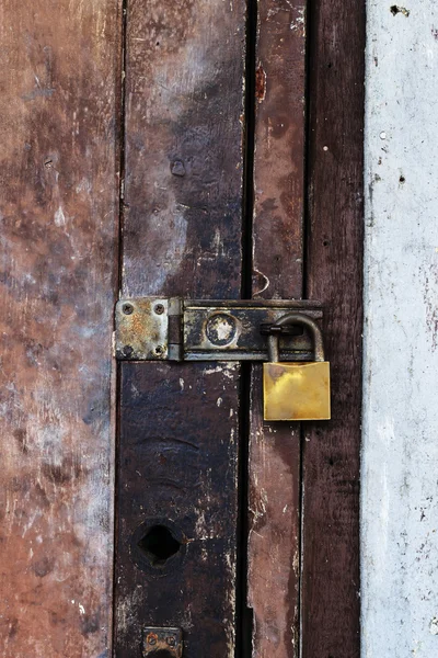 stock image Old padlock on a wooden door