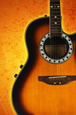 Acoustic guitar on abstract background. clipart