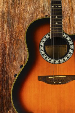 Acoustic guitar on a wood background. clipart