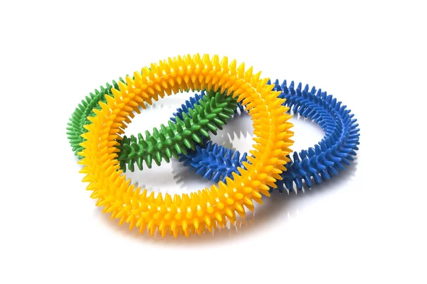 Fehér alapon kék, sárga és zöld masszázs gyűrűk — Stock Fotó