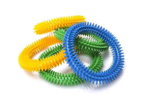 Fehér alapon kék, sárga és zöld masszázs gyűrűk — Stock Fotó