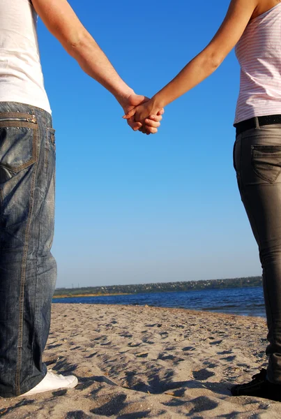 Couple holding hands on the beach — Stock Photo, Image