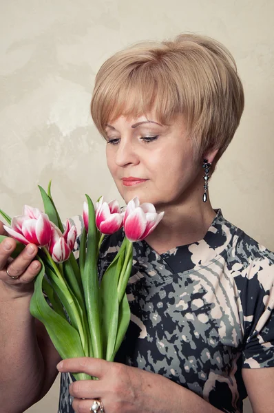 stock image Beautiful woman holding flowers