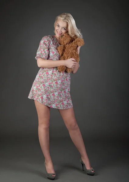 Beautiful blonde woman with teddy bear — Stock Photo, Image