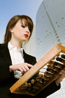 Businesswoman with wooden abacus. clipart