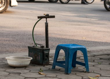 Vietnam Hanoi, Simple Bike tire repair stand along clipart