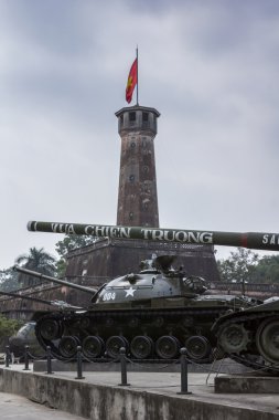 Tanks at military museum in front of Cot Co tower with flag. clipart