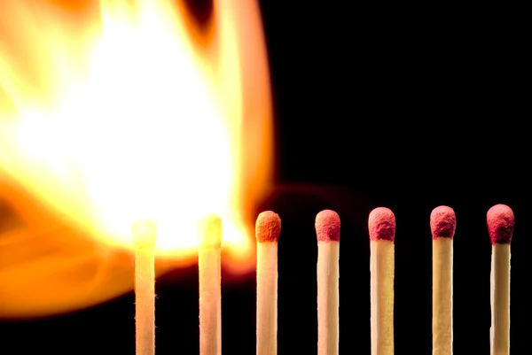 Fire (large fire and matches on a black background). — Stock Photo, Image
