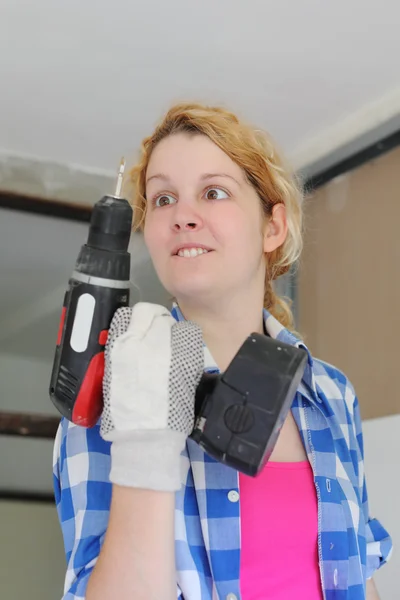 Squint girl with drill — Stock Photo, Image