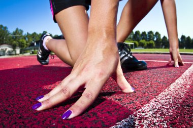 Wide shot of woman on the start line before sprint clipart