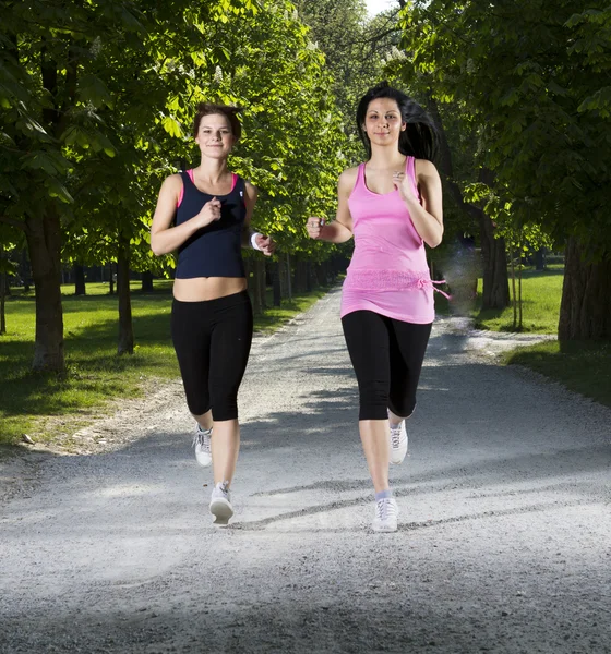 Young girls jogging in the park — Stock Photo, Image