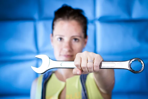 stock image Woman holding wrench