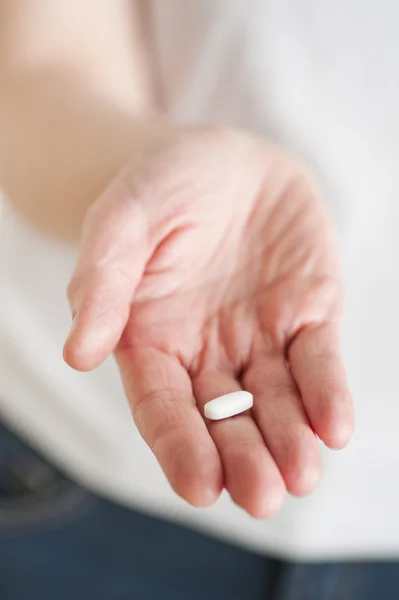 stock image Hand holding a white pill