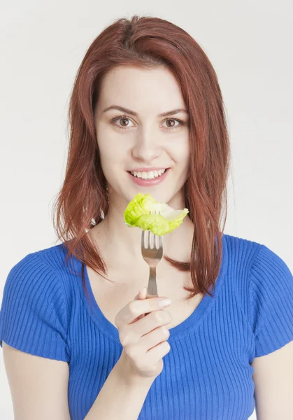 Νεαρή γυναίκα τρώει μαρούλι — Φωτογραφία Αρχείου