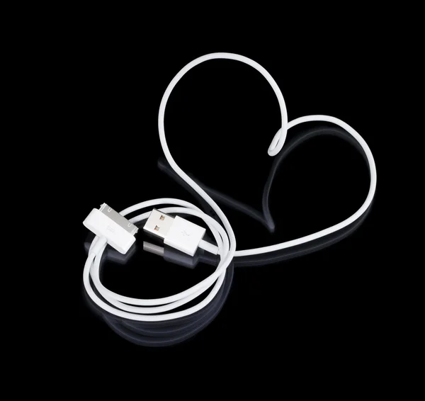 The white cable is a heart-shaped with connectors on a black bac — Stok fotoğraf