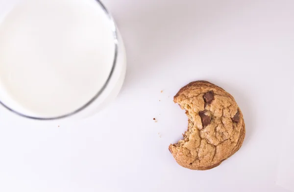 stock image Bitten Chocolate Chip Cookie with a Glass of Milk