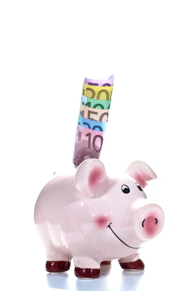 Piggy bank met eurobankbiljetten in de sleuf — Stockfoto