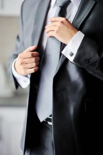Groom getting ready holding a tie — Stock Photo, Image