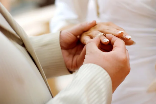 stock image Groom putting a wedding ring on bride's finger