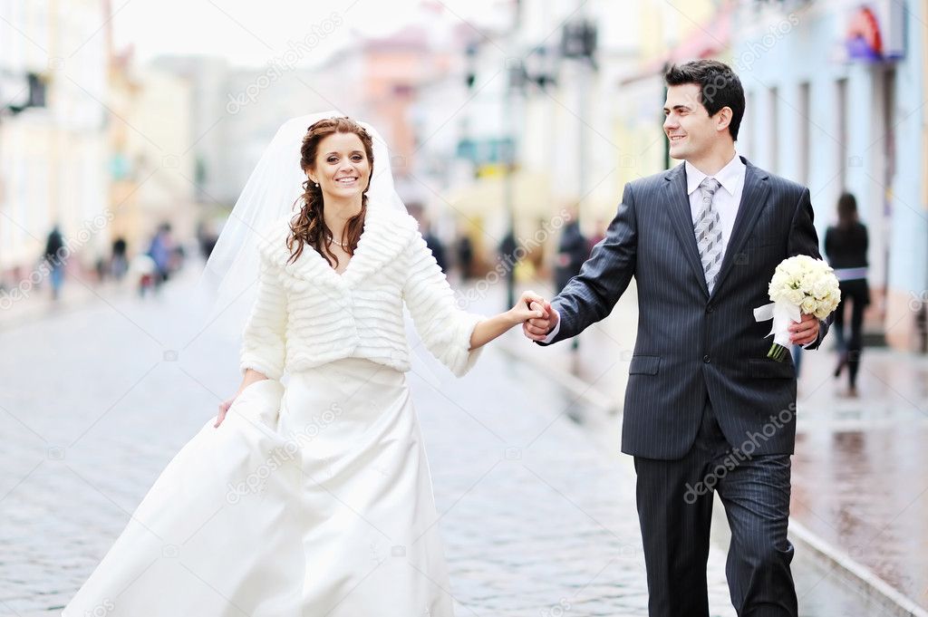Bride and groom walking together hand in hand