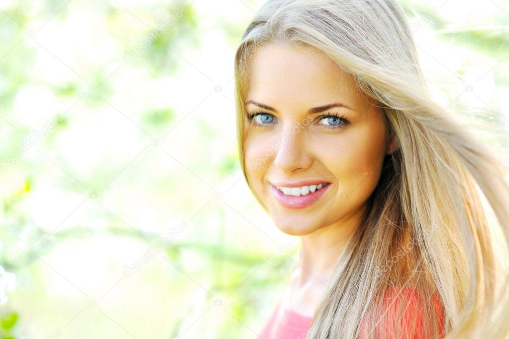 Closeup of happy cheerful smiling young beautiful blond woman, o
