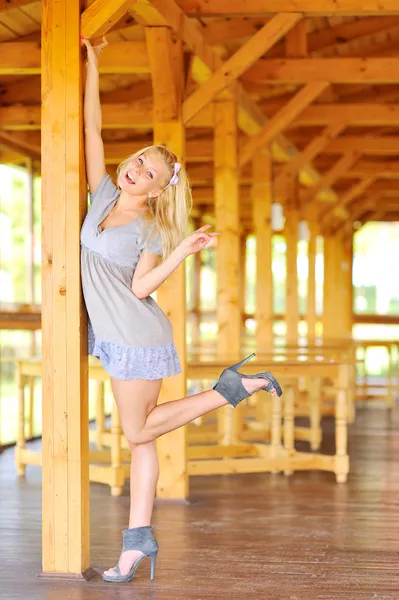 Ung dam poserar nära trä struktur — Stockfoto